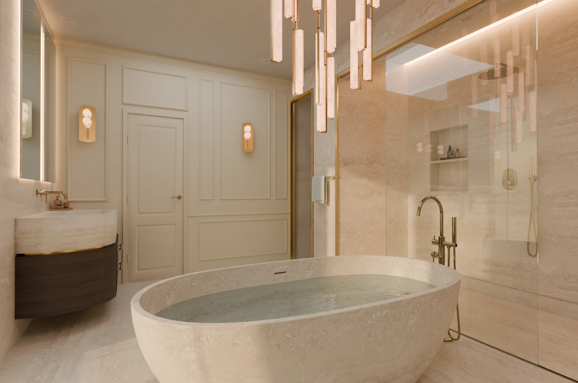 Freestanding stone bath beneath glass and brass pendant lights